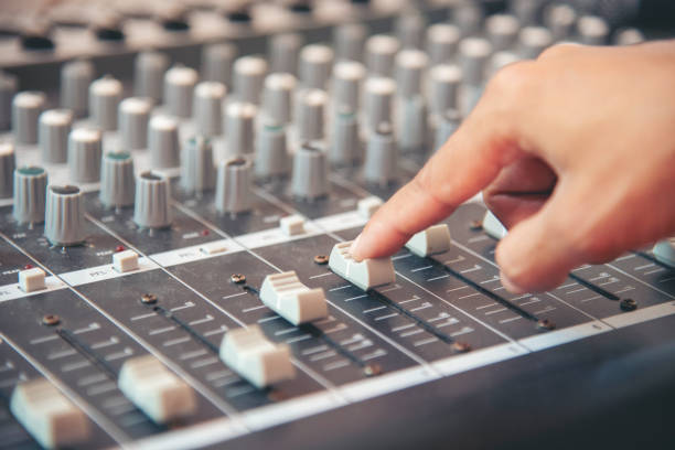 istock Production sound engineer hands working on recording studio mixing voice control. Expert adjusting volume equalizer voice, mixing console DJ sound engineering. Producer remix tune music sound record 2150944127