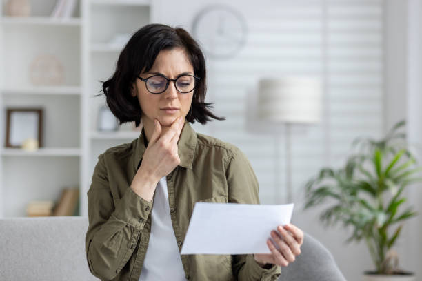 istock Mature woman confused while looking at a bill 2150946865