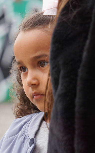 istock A shy girl hides behind parent 2150947404