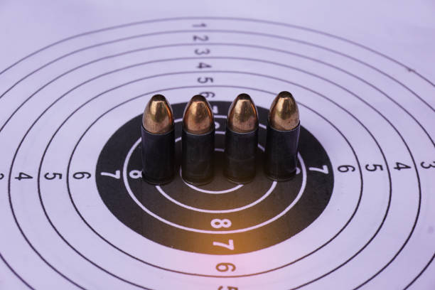 istock Black 9mm bullets on shooting target paper, soft and selective focus. 2150948060