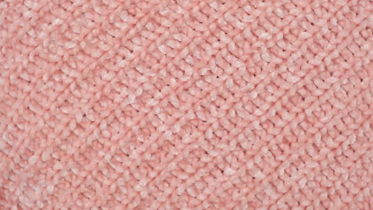 Soft Knitted Woolen Detailed Texture. Natural Fabric Closeup Knit Pattern. Beige Knitwear, Warm Cashmere Surface. Rotation, Macro. Cozy Creamy Textile Background. Clothes Production. Melange Yarn. 4K