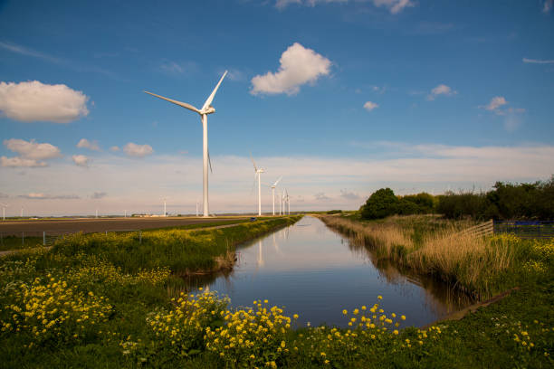 istock wind turbines near the canal 2150948450