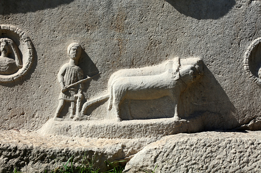 A sarcophagus from the Roman period exhibited in the Antalya Archaeological Museum. There is a figure of a farmer plowing with a plow on the sarcophagus.