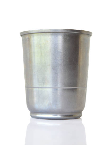 istock Vertical image of cut out of one empty solid durable reusable sturdy safe metal shiny stainless steel drinking glass with reflection, cup, mug or cup, container without lid front view over blank white transparent background 2150949389