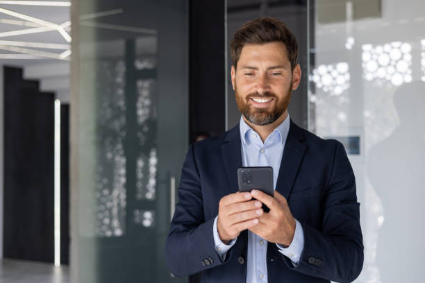 istock Confident businessman using smartphone in modern office 2150949919