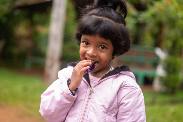 istock A girl eating chocolate in the park 2150950489