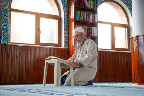 istock Imam Muslim reading holy book Quran at the mosque 2150950738