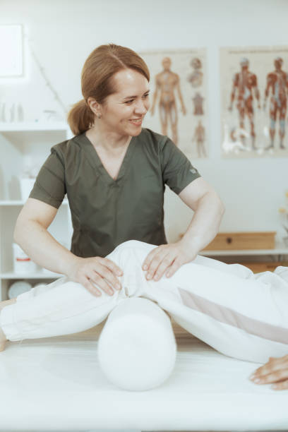 istock smiling female therapist in massage cabinet doing checkup 2150950764