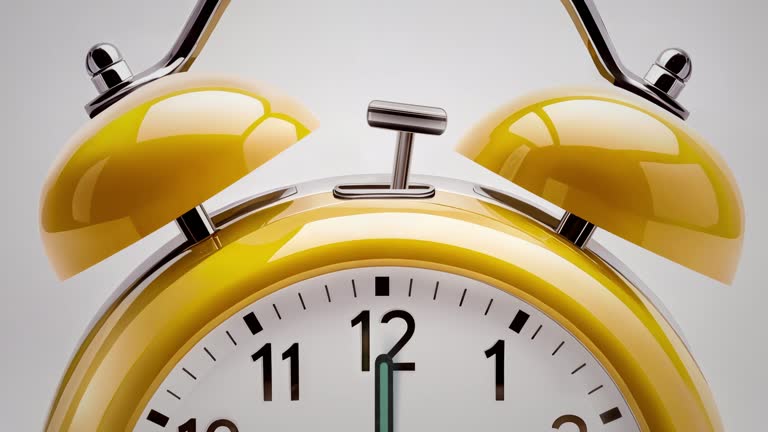 Alarm clock ringing at 05:00 o'clock. It's ticking quickly  on a white background in the studio lights. The concepts of speed, time, deadline, waking up, stress, bell rings, hour, time lapse, schedule, calendar date, finalize, retro style
