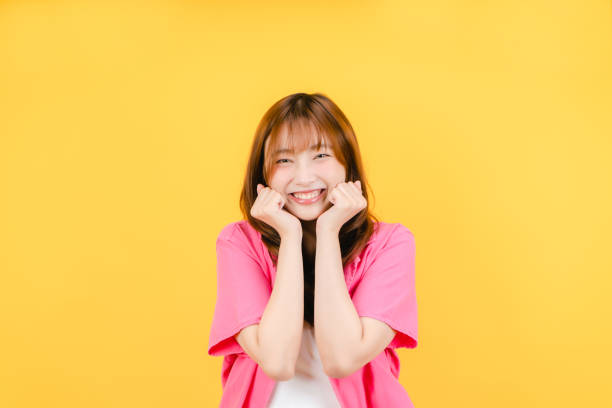 Living room, A beautiful young woman is smiling and relaxing at home with her head on her arms