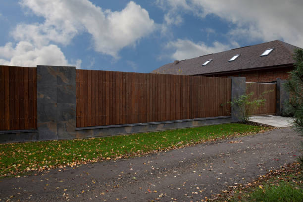 istock Brown wooden fence with linear planks on a sky background 2150952416