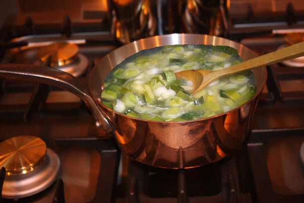 Cubed vegetables including leak and onion in water for a vegetable soup.