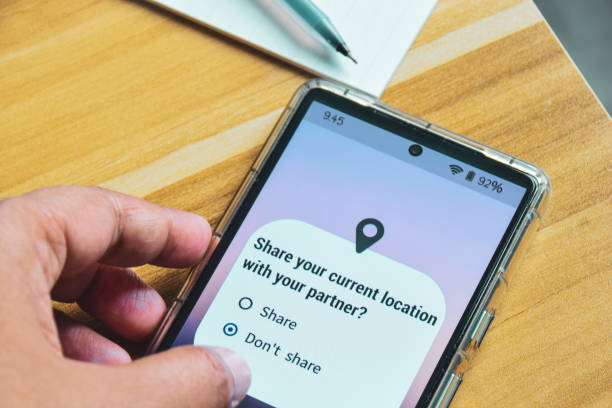 istock Mobile phone screen displaying the message Share your current location with your partner. Person decision not to allow it. Relationship trust issues concept. 2150955163