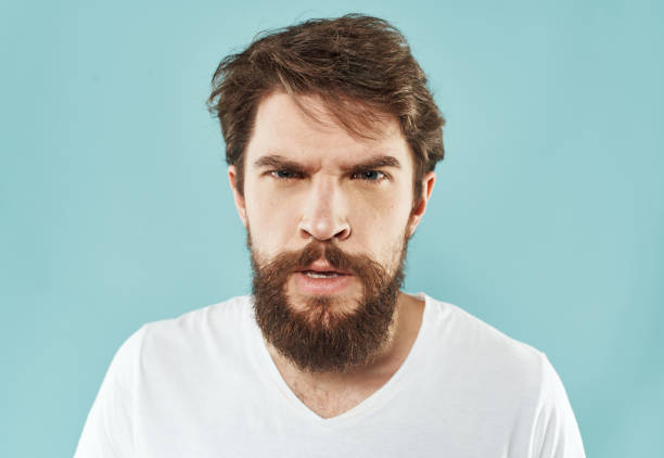 istock aggression stress man with a beard emotions indignant look fist 2150956444