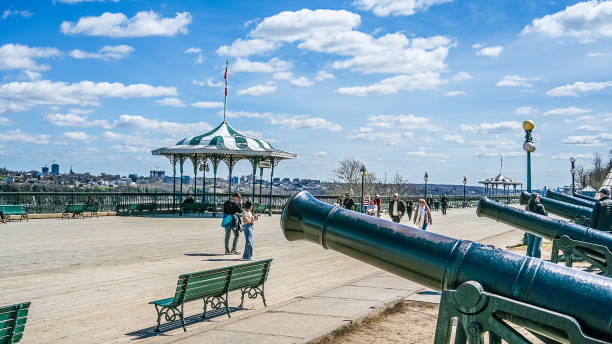 Group of people walking on Dufferin boardwalk in Old Quebec during springtime day