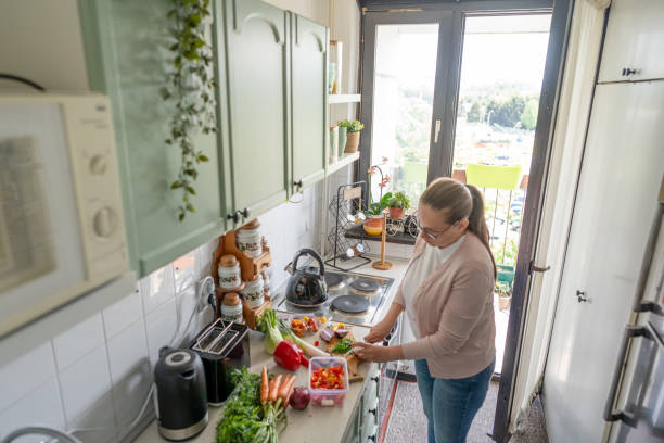 istock Woman making fresh salad at home 2150957445