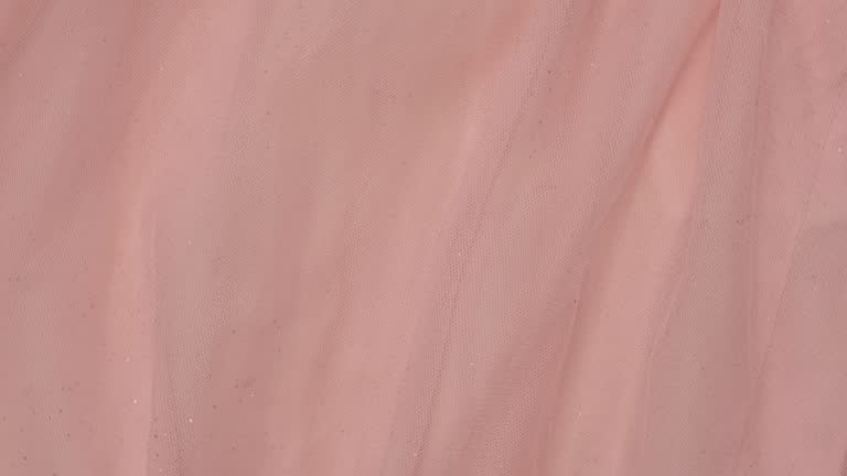 Soft Chiffon Detailed Texture. Natural Mesh Fabric Closeup Knit Pattern. Pink Light Polyester Surface. Rotation, Macro. Cozy Textile Background. Clothes Production. Melange Yarn. 4K Shot