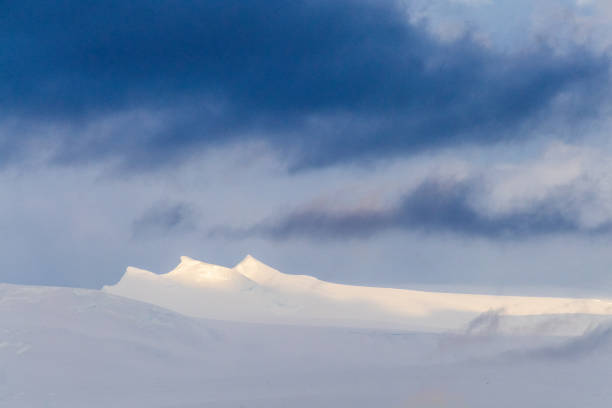 An Antarctic landscape, taken during the golden hour, just after sunrise, in the Gerlache Strait.