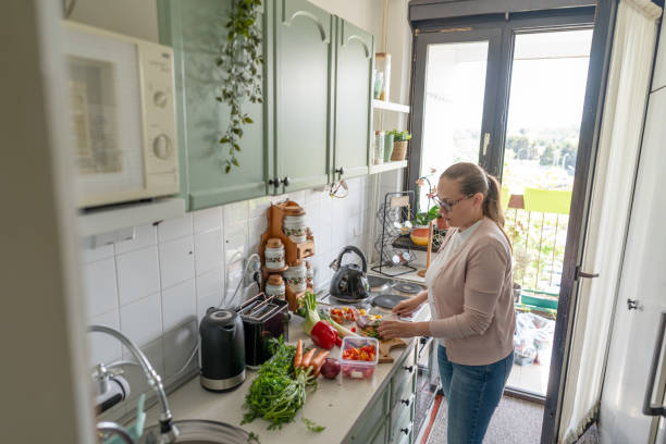 istock Woman chopping vegetables at home 2150958554