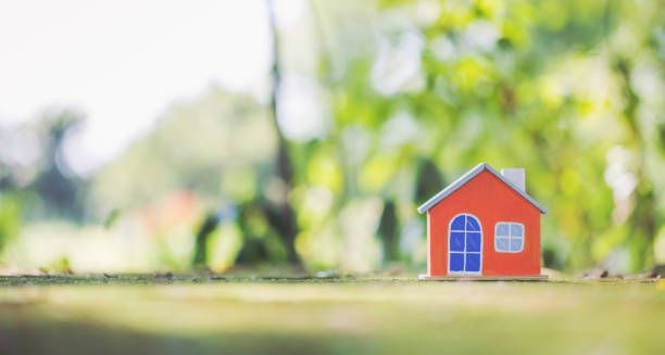 istock Wooden Orange house model on moss. 2150960125