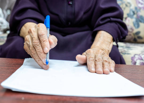 istock Old muslim woman signing some documents 2150961652