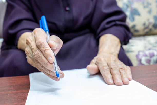 istock Old muslim woman signing some documents 2150961672