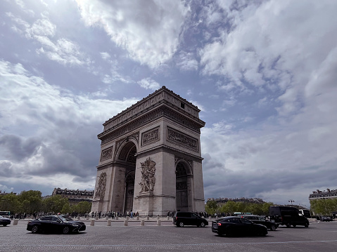 Triumphal arch in Paris capital of France, famous tourist attraction on cloudy day, monument to glorify Napoleon victory, national heritage, Arc de Triomphe on Charles de Gaulle square, city scenery