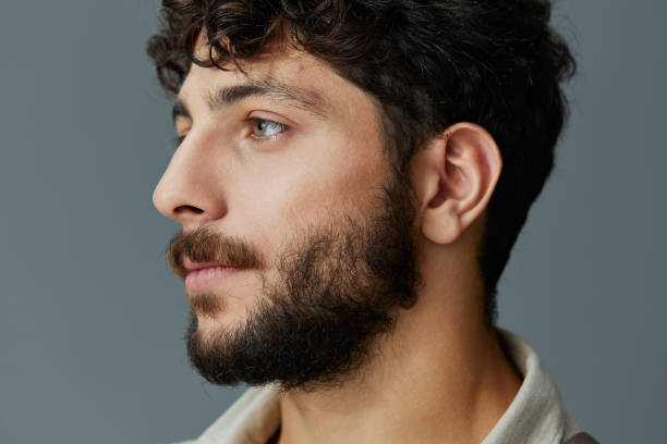 istock Handsome man background portrait face serious beard young isolated guy model person white 2150962327