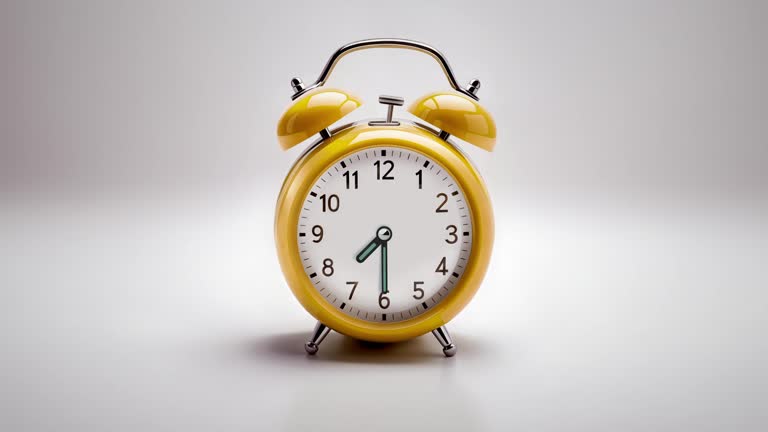 Alarm clock ringing at 07:30 o'clock. It's ticking quickly  on a white background in the studio lights. The concepts of speed, time, deadline, waking up, stress, bell rings, hour, time lapse, schedule, calendar date, finalize, retro style