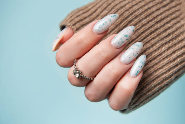 istock Female hands with blue nail design. Blue nail polish manicure. 2150966919