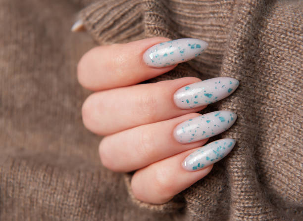 istock Female hands with blue nail design. Blue nail polish manicure. 2150966944
