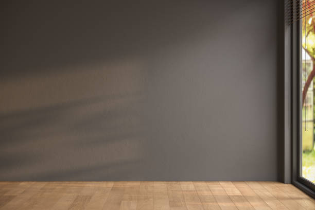 Empty room with black walls, parquet floor and view yard from window, simple minimalist interior architecture background with copy-space,