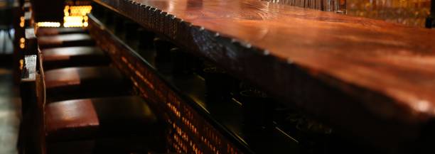 istock Wood stools at empty wooden bar counter 2150968167