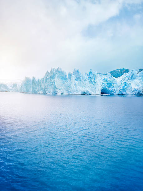 istock iceberg floating in the arctic sea with small waves on a sunny day. Melting ice. Climate change concept. 2150968552