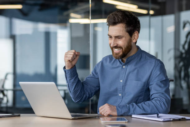 istock Successful man celebrating a victory in office 2150968611