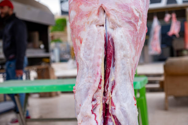 Bearded man cutting meat for poor peoples during eid in butchery
