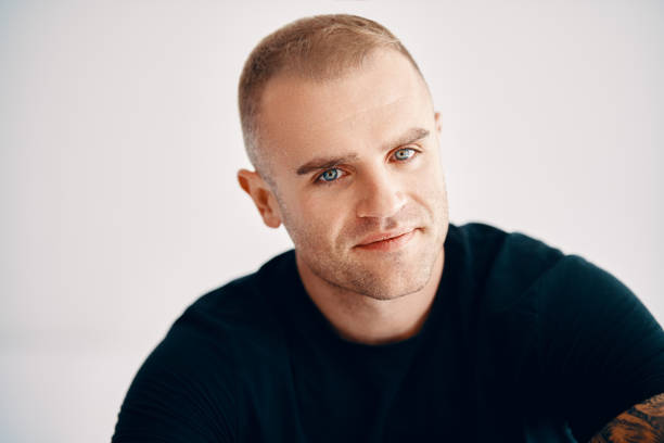 istock Handsome young man looking to camera over soft white background 2150970924