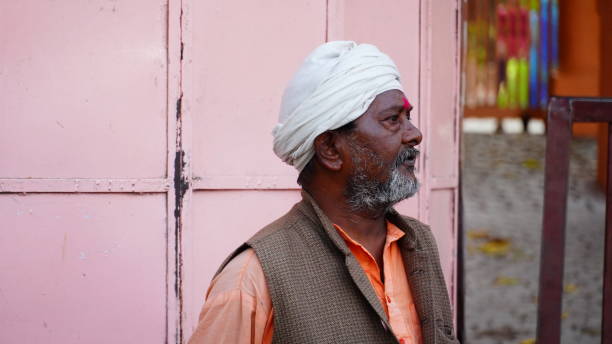 Rajasthan, India - February 25, 2006: Portrait of an old peasant with glasses and turban during a gathering of people in the village of Nayla