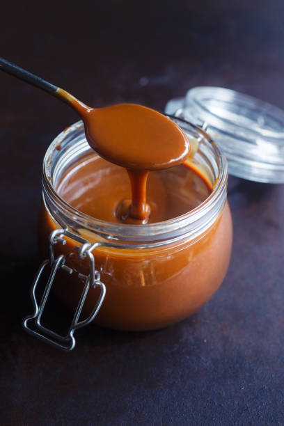 istock homemade caramel sauce in jar. 2150972492