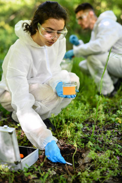 istock Female Scientist Gathering Wet Soil From Mountain For Lab Research 2150976172