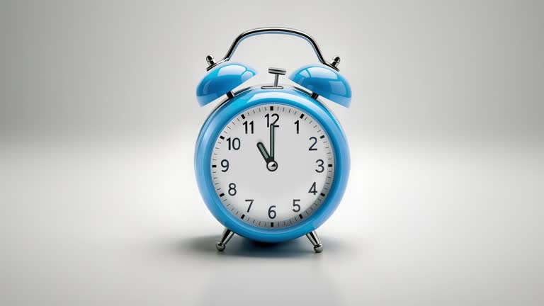 Alarm clock ringing at 11:00 o'clock. It's ticking quickly  on a white background in the studio lights. The concepts of speed, time, deadline, waking up, stress, bell rings, hour, time lapse, schedule, calendar date, finalize, retro style