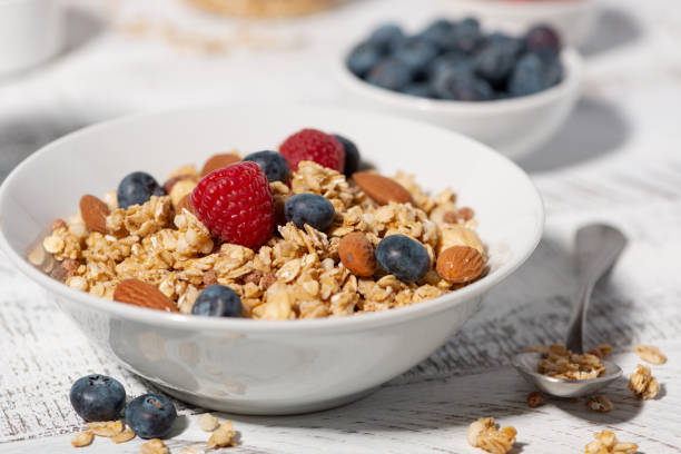 istock homemade granola with nuts and fresh berries on white table, closeup 2150978066