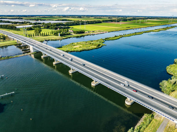 istock Traffic driving over a bridge over a lake in a nature reserve 2150978417