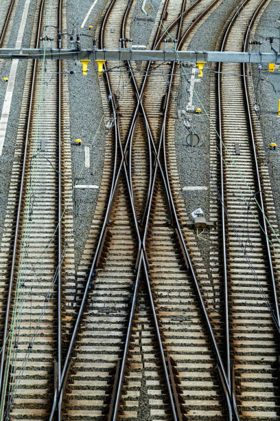 half asphalt and half railroad tracks. top view of indonesian railway station platform