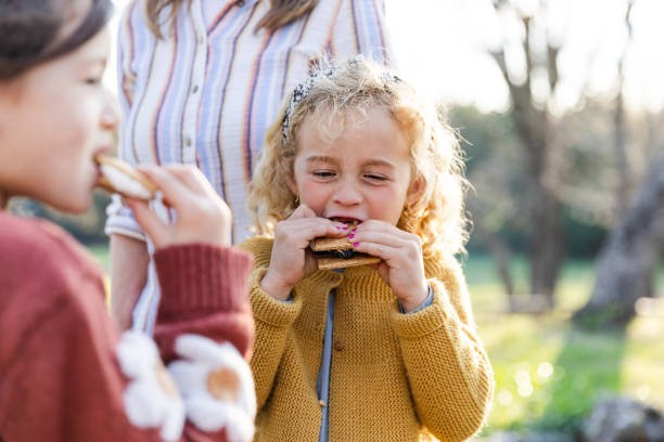 istock Young sisters happily enjoy their smores outside 2150980166