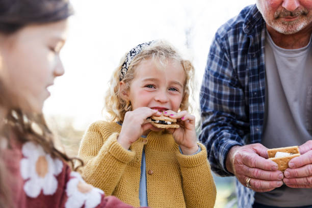 istock Young girl looks at the camera while enjoying a smore 2150980181