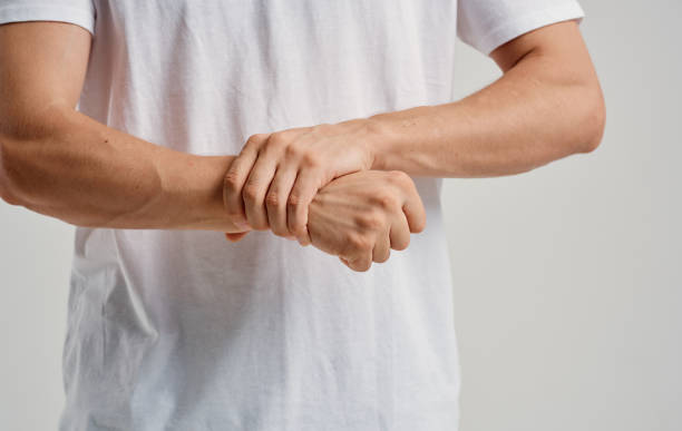 istock a man in a white t-shirt touches his wrists on a light background 2150980453