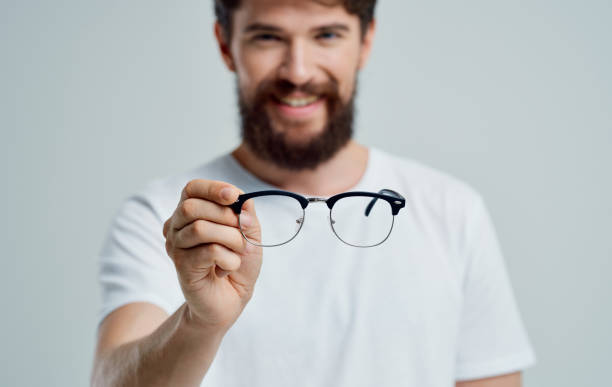 istock a man with glasses in his hand vision problems eye pain myopia hyperopia lenses 2150980873