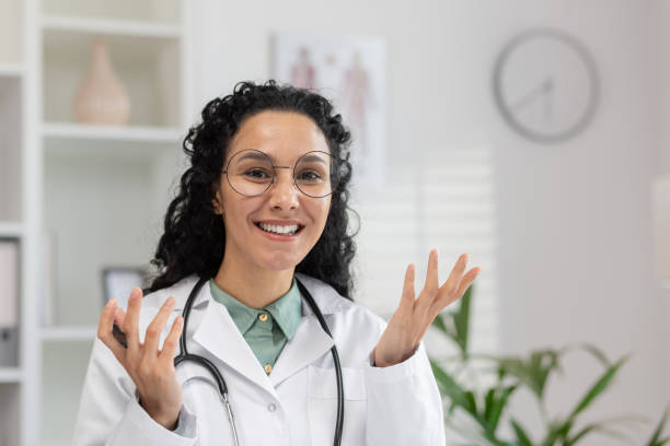 istock Friendly female doctor engaging in a video call with patients 2150984158
