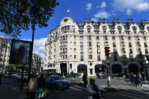Paris, France-04 28 2024: People passing in front of the Hotel Lutetia, located in the Saint-Germain-des-Prés area of the 6th arrondissement of Paris, France and one of the best-known hotels on the Left Bank.
